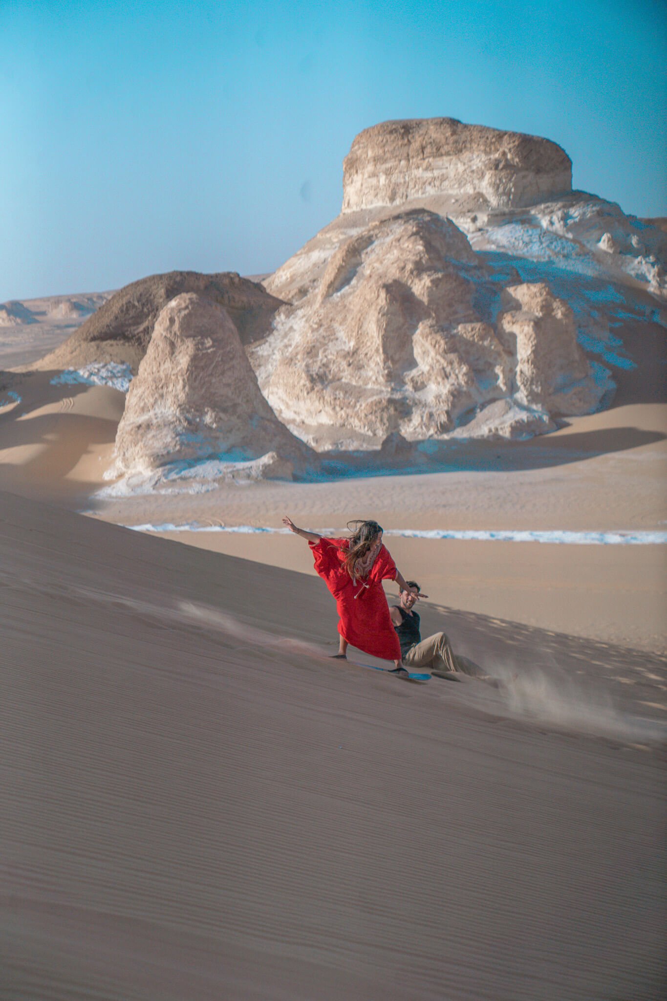 sand boarding on the sand dunes of the White desert in Egypt
