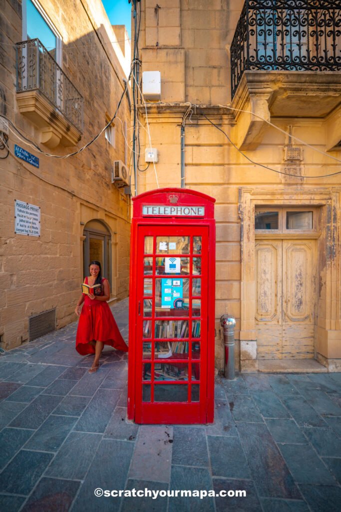 red telephone booth in small town in Gozo, Malta