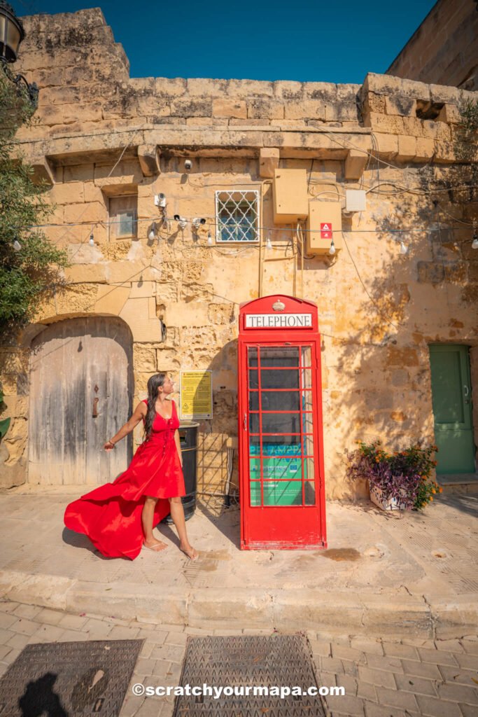 red telephone booth in small town in Gozo, Malta